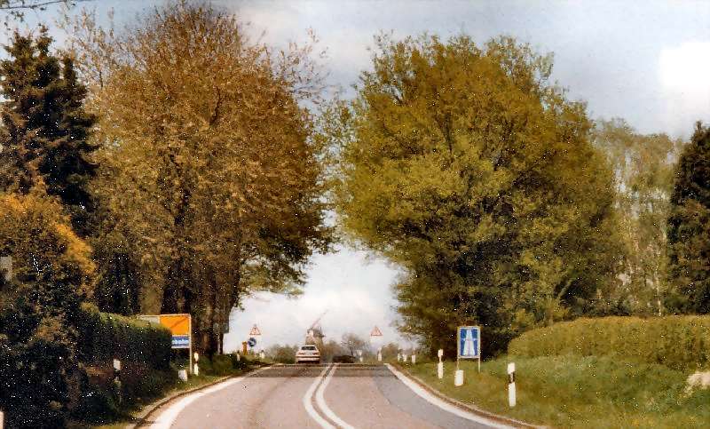 1991 - Noch führt die A-2-Auffahrt in Richtung Hannover durch die beiden Teile des Friedhofes in Exter (links der alte, rechts der neue). Das Fahrzeug bewegt sich scheinbar direkt auf die etwa 1 km in Luftlinie entfernte Windmühle zu.